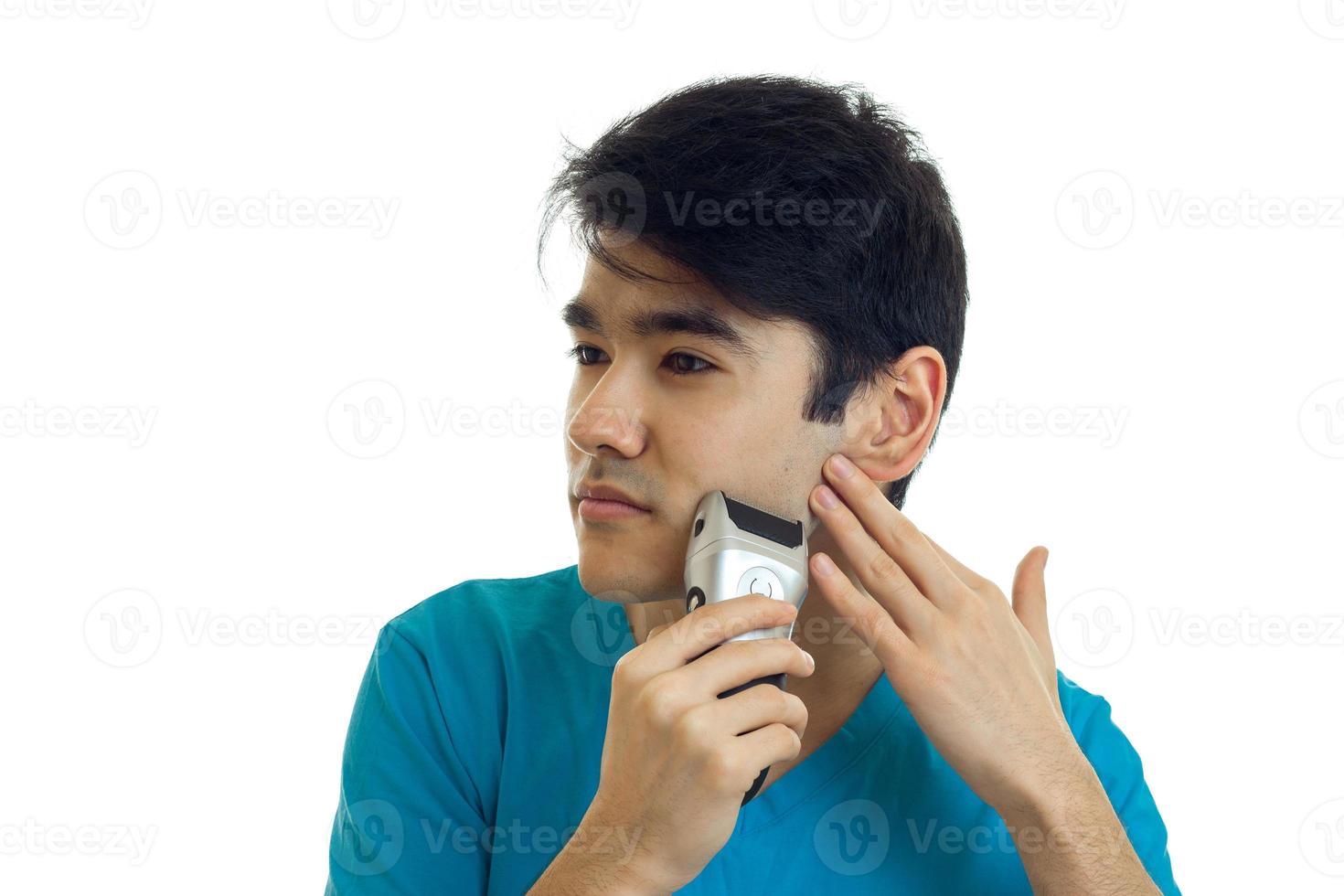 Portrait of a young handsome guy with black hair that turned my head sideways and shaves photo