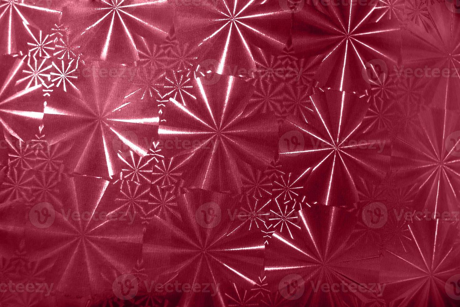 Abstract pattern with round segments with rays on holographic paper in color 2023 Viva Magenta. photo