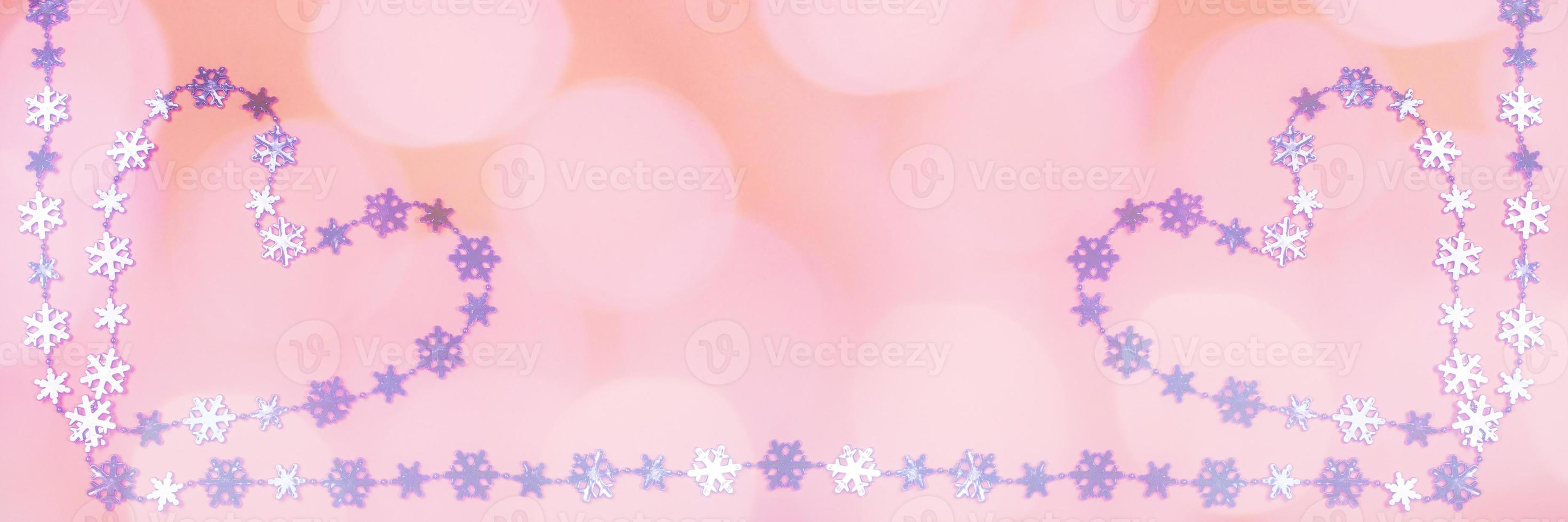 Creative wide Valentine's day banner with two heart of shiny lilac metallic snowflakes on pink background with bokeh. photo