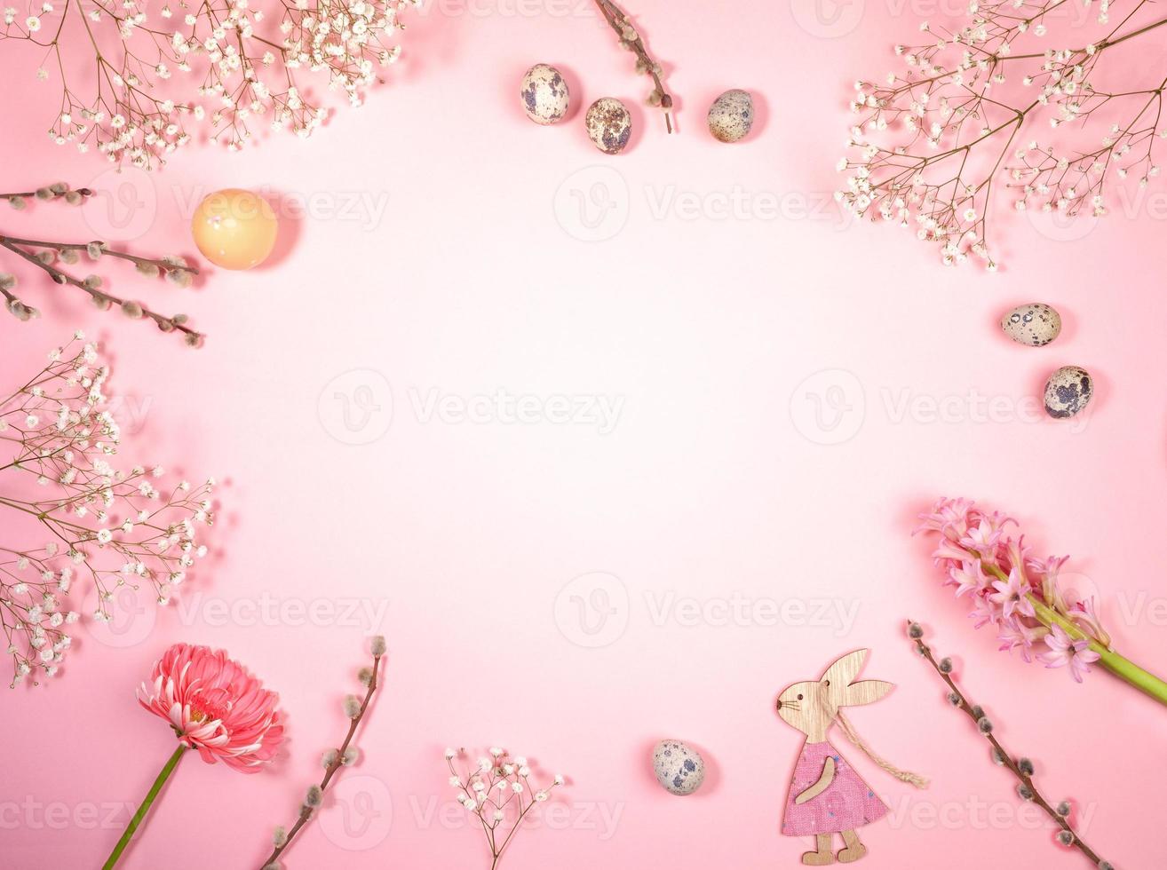 Flat lay Easter symbols arrangement laid out on pastel pink. Festive layout. Horizontal orientation. Copy space. photo