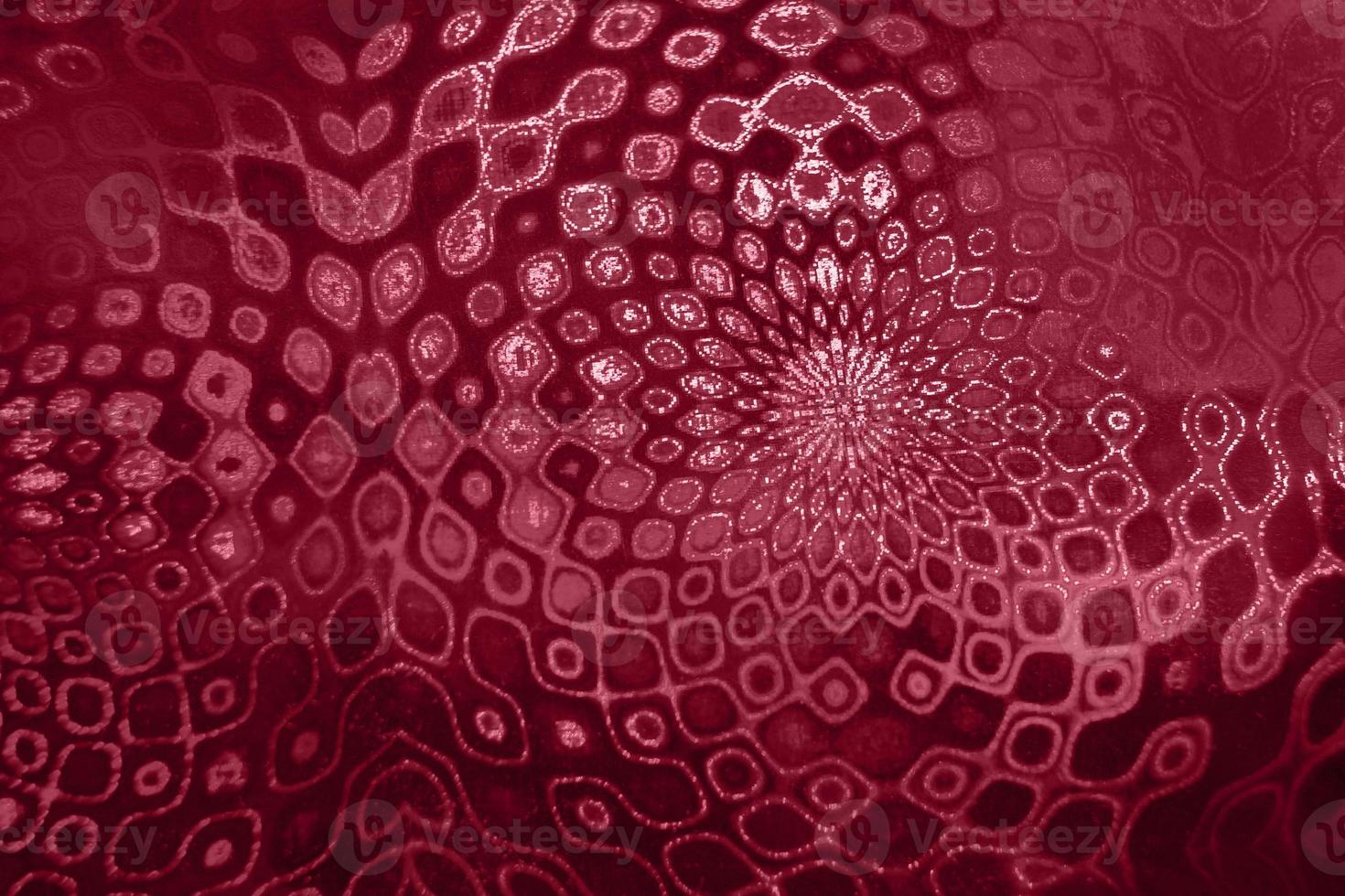 Fancy pattern of holographic paper like mandalas toning in color 2023 Viva Magenta. photo