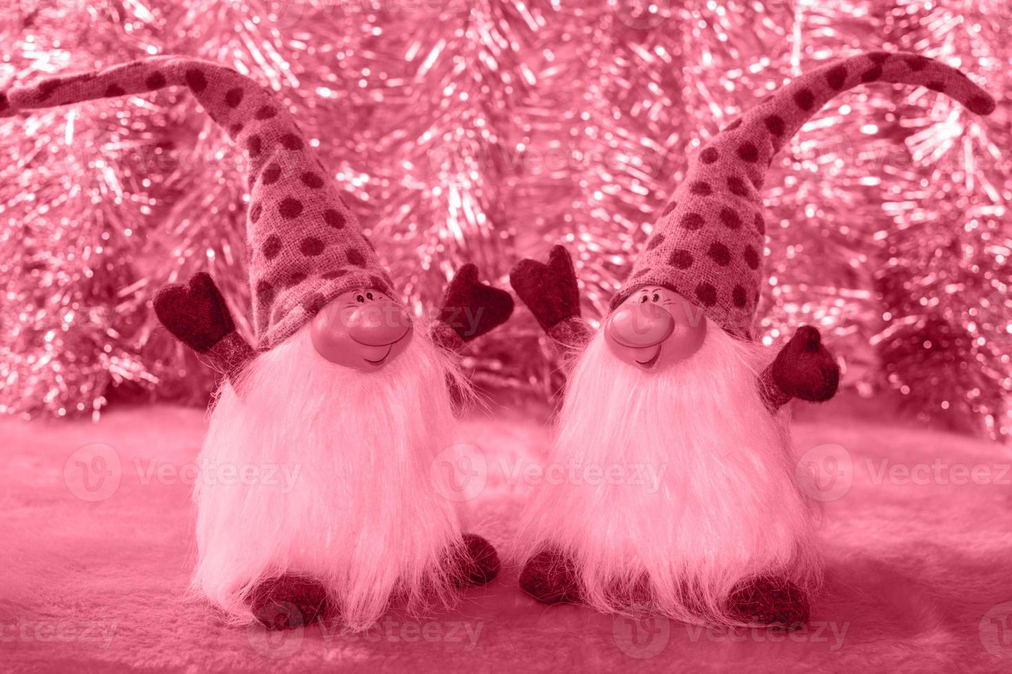 Two cheerful dwarves on festive blur bokeh background toning in PANTONE 18-1750 Viva Magenta color. photo