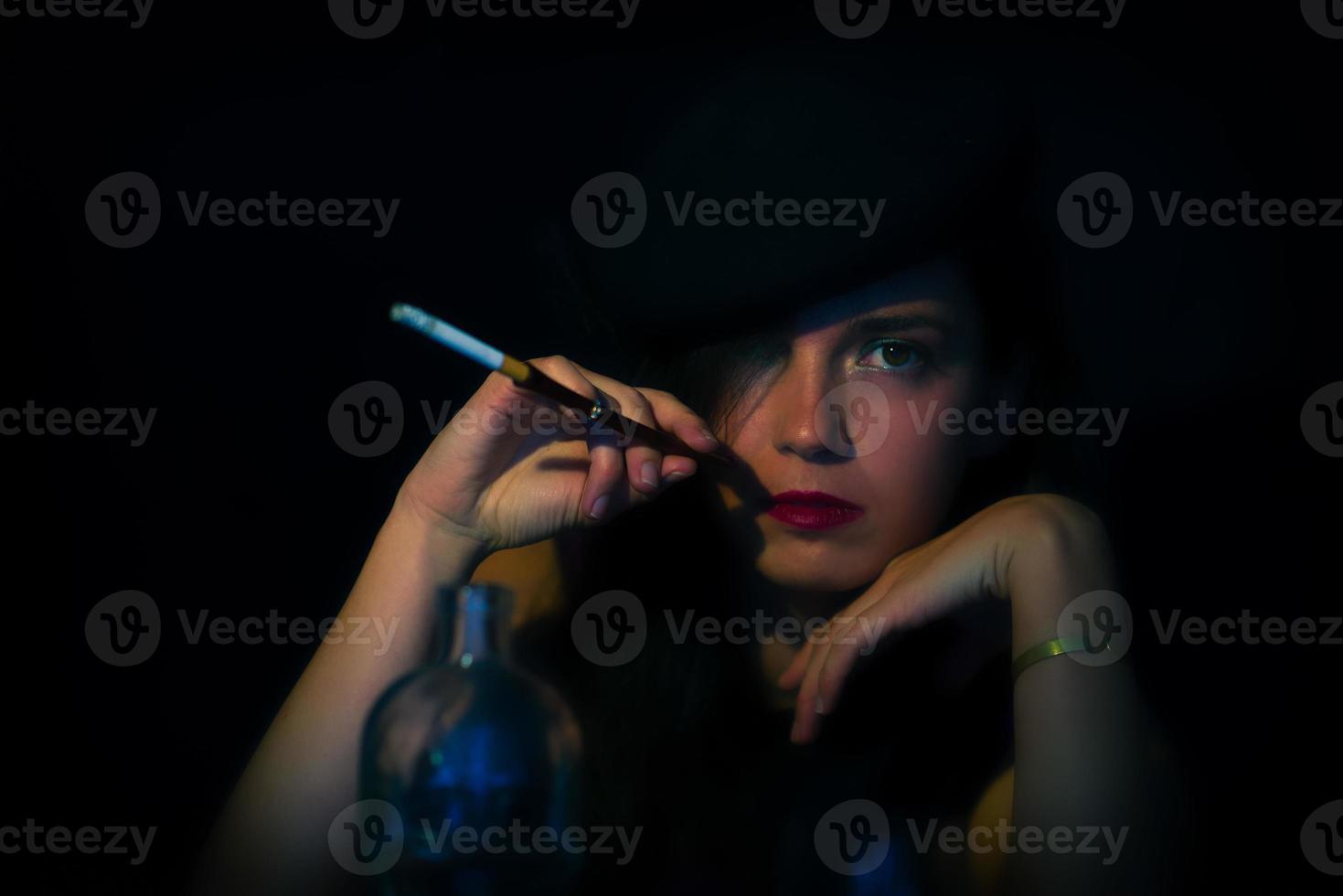 Retro woman with mouthpiece cigarette and alcohol. retro style photo