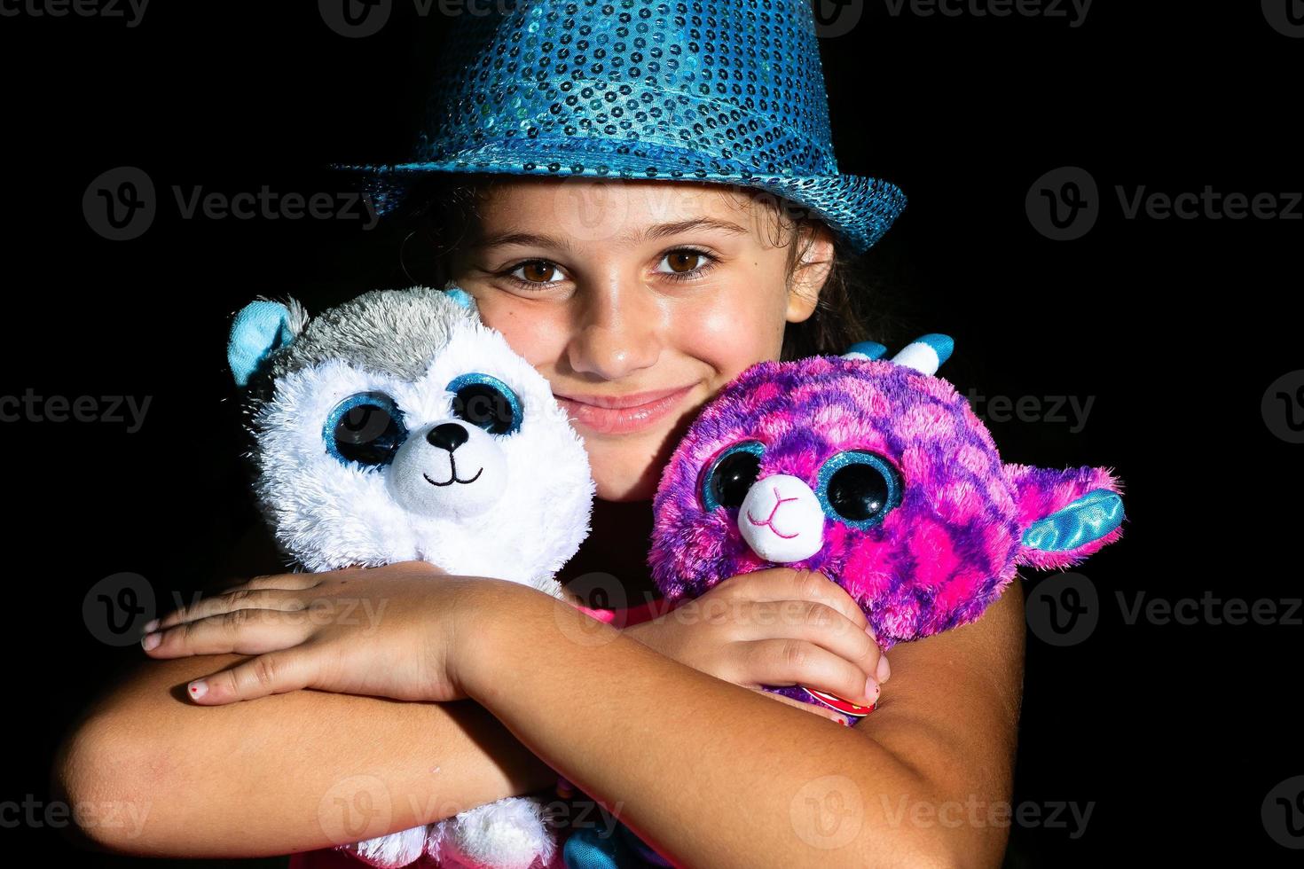 A little girl with two soft toys photo
