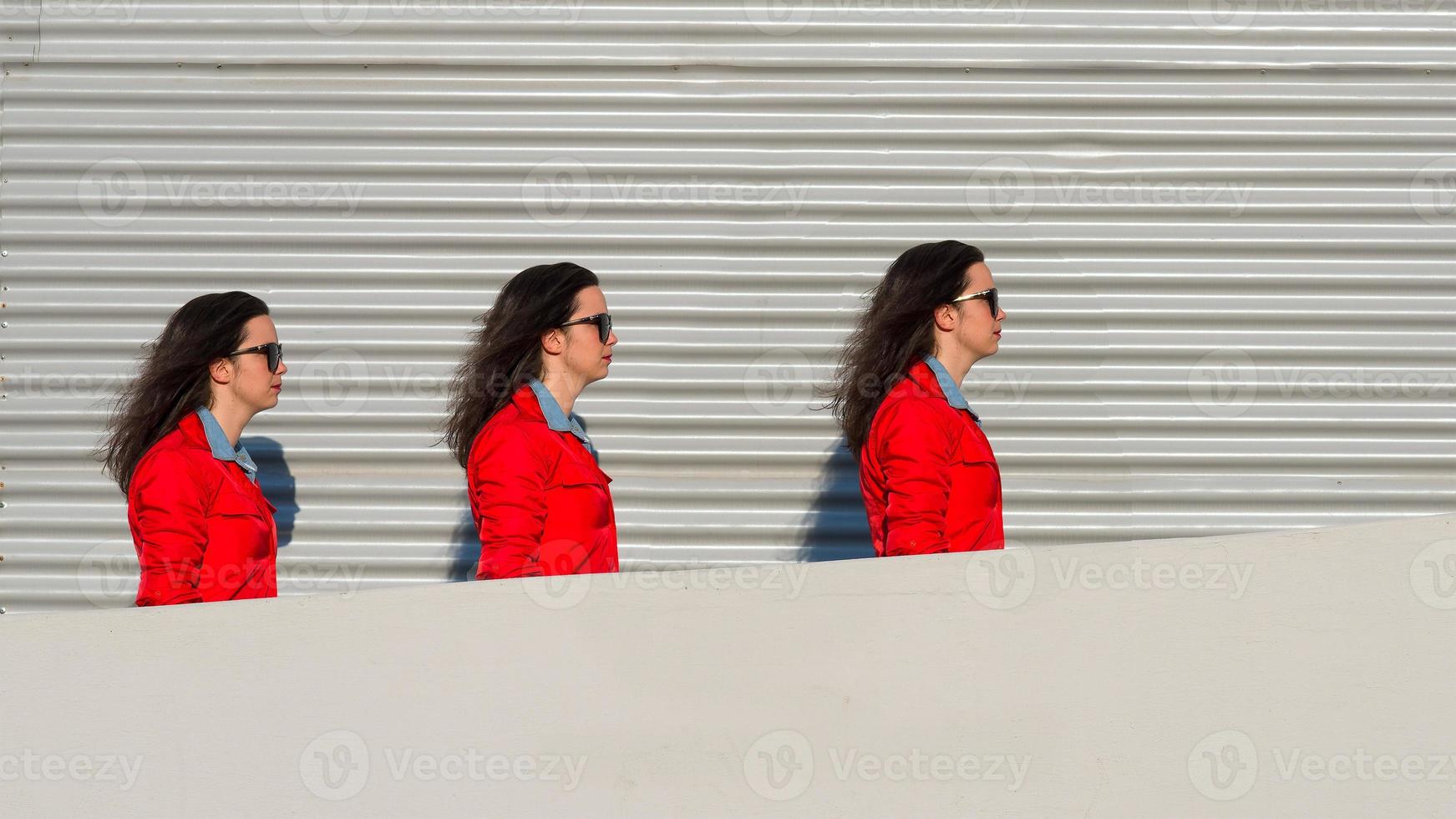 Threefold girl walks between a wall and sheet photo