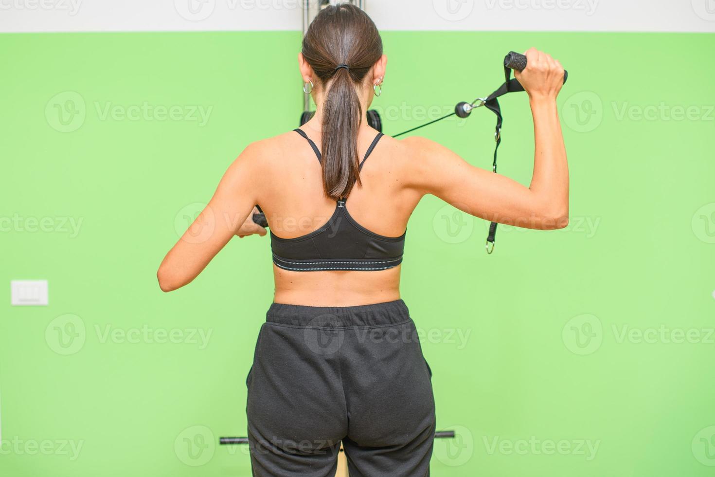 A girl performs shoulder and back exercise photo