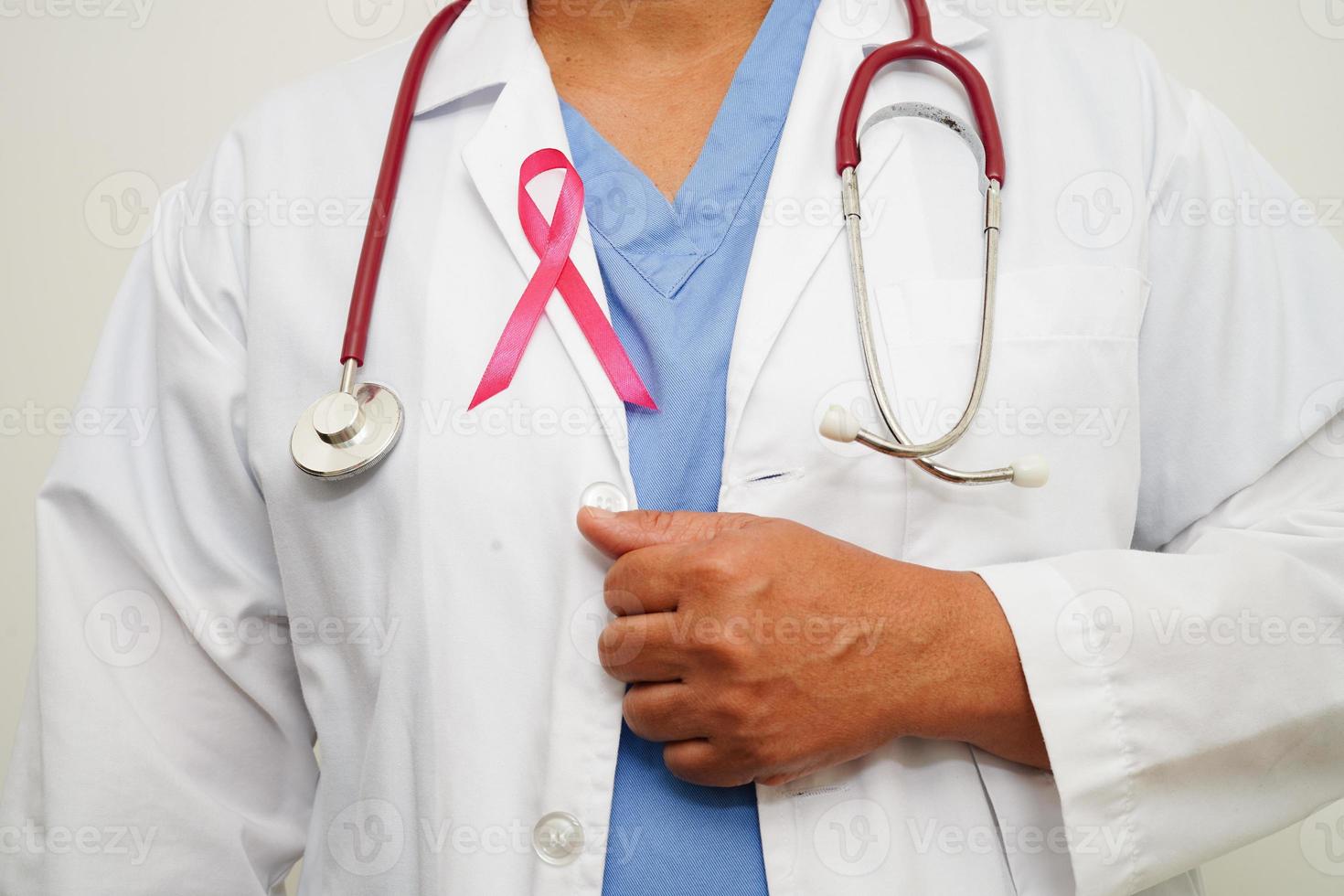 Asian woman doctor with pink ribbon, World Breast Cancer Day at October. photo