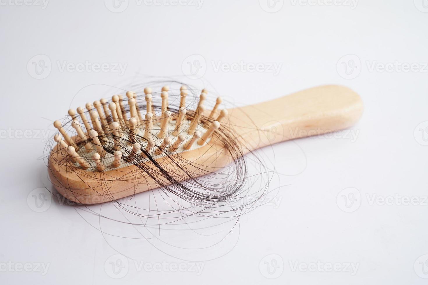 Hair loss fall with comb brush isolated on white background. photo