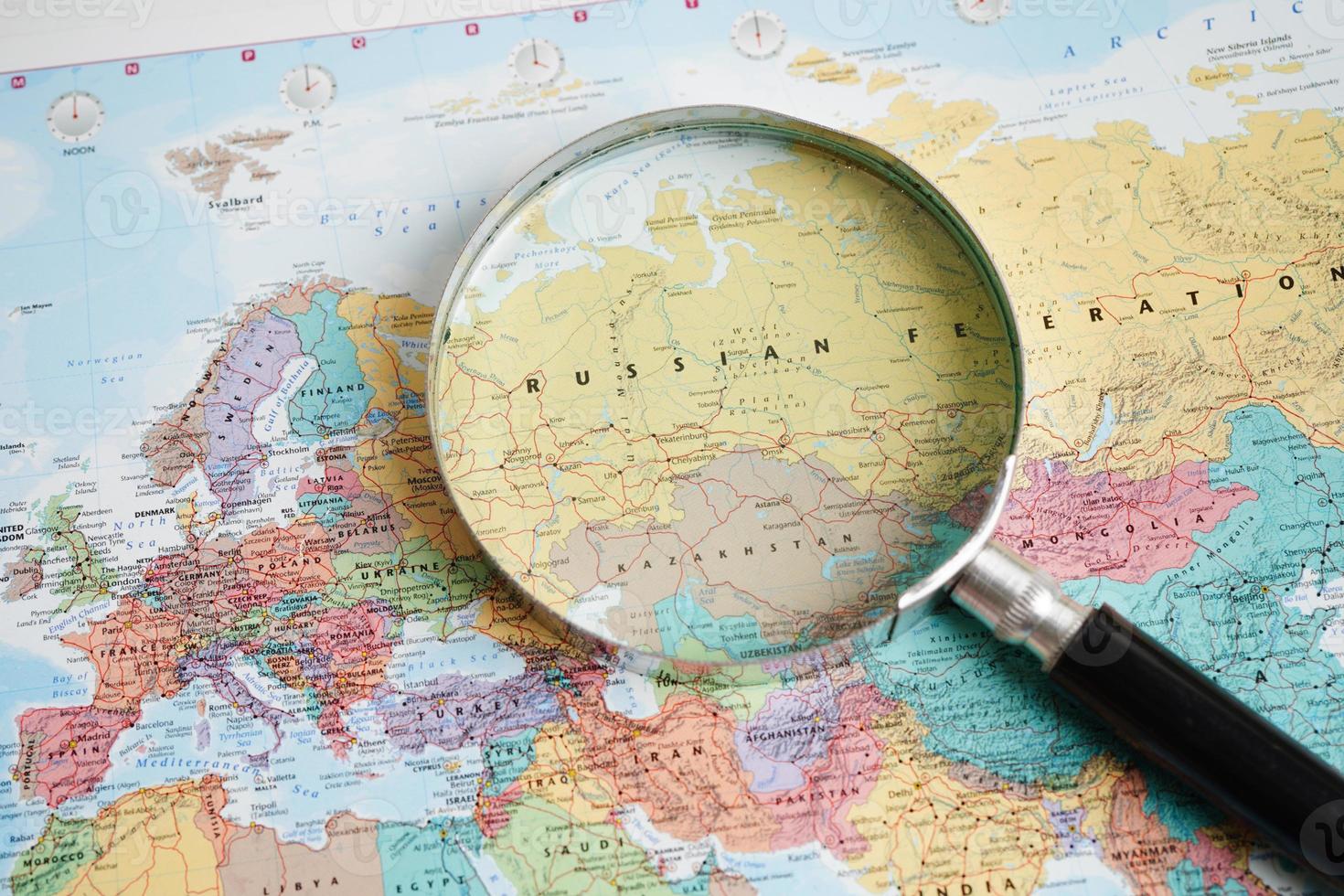 Bangkok, Thailand - May 15, 2022 Magnifying glass on world map. photo