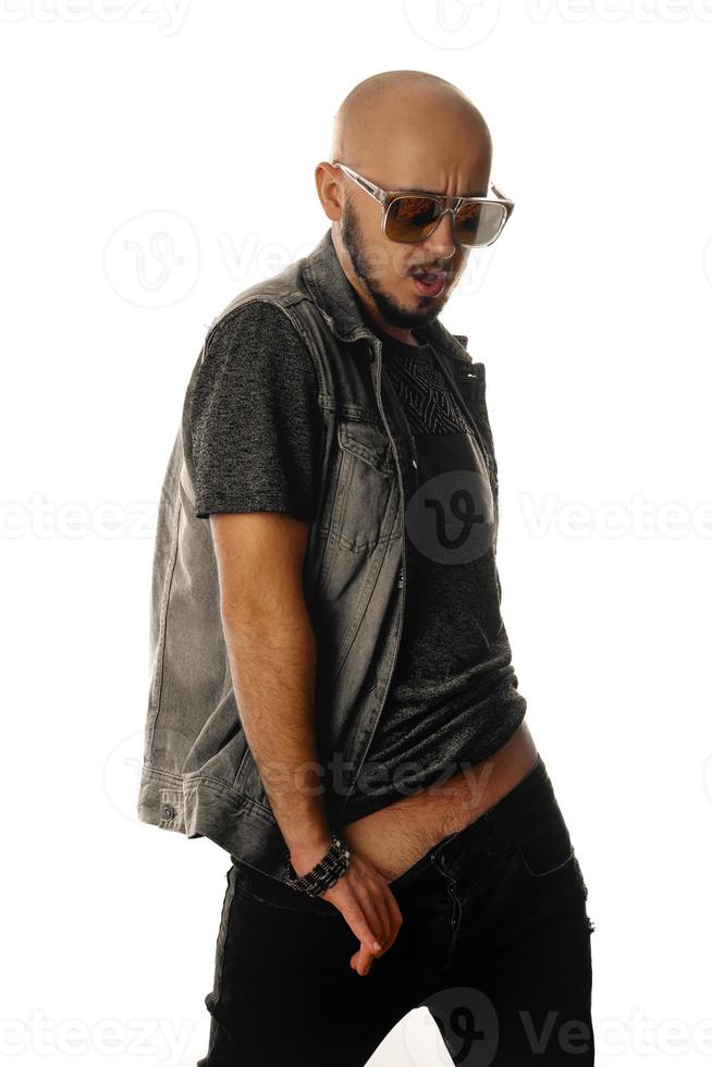 hot sexy macho in sunglasses posing in studio and looking away with opened mouth photo