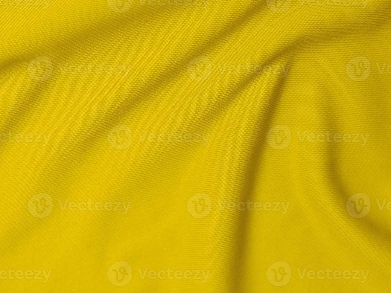 textura de tela de terciopelo amarillo utilizada como fondo. fondo de tela amarilla vacía de material textil suave y liso. hay espacio para el texto foto