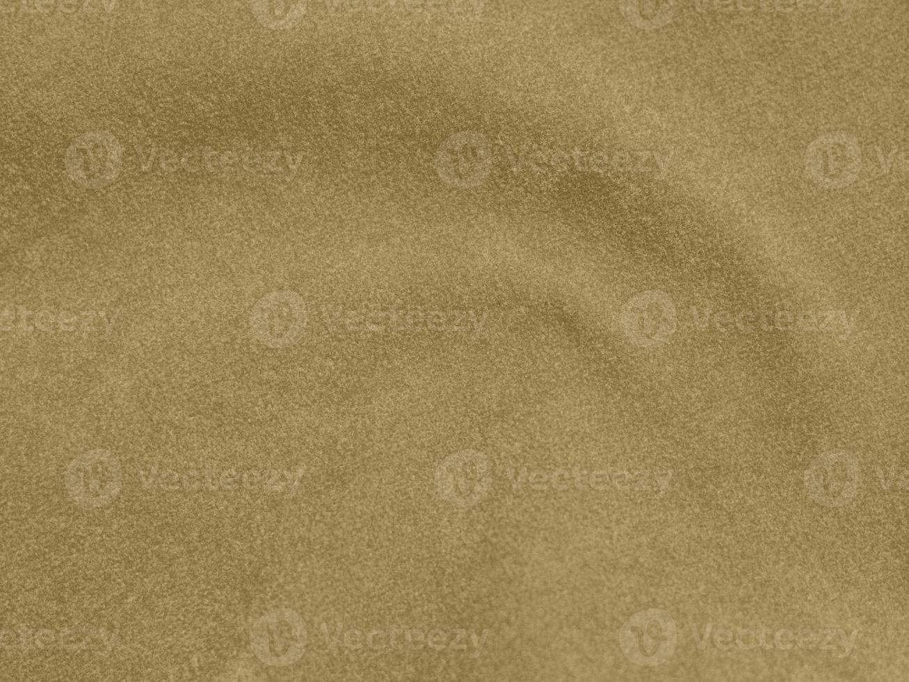 gold color velvet fabric texture used as background. blond color fabric background of soft and smooth textile material. There is space for text. photo