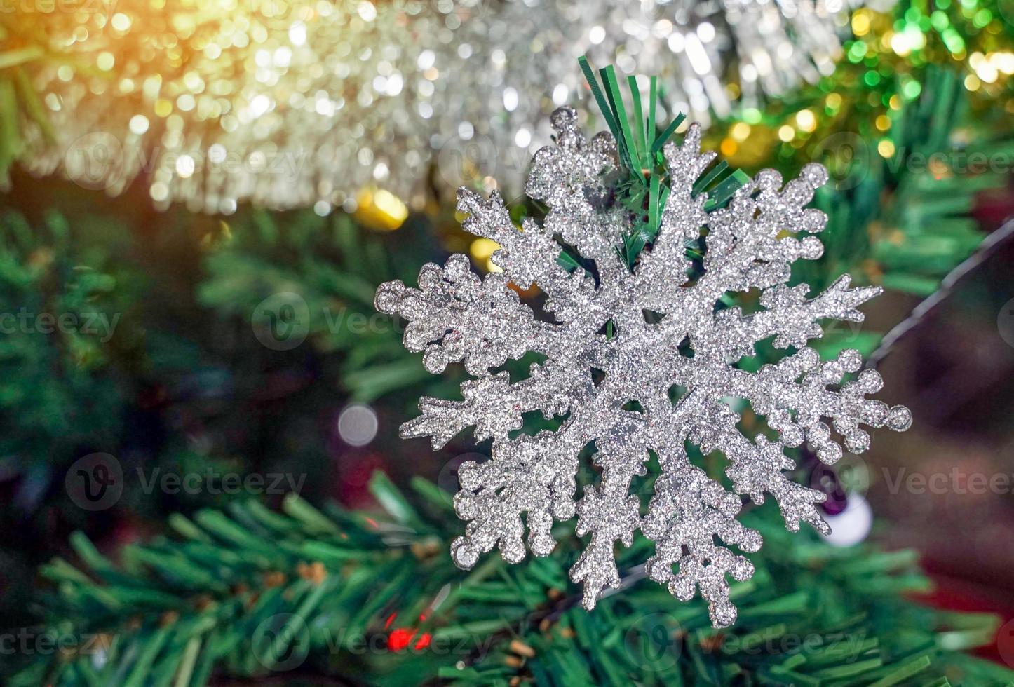 Glistening white snowflakes decorate the Christmas tree to prepare for the festive season of Christmas every year. soft and selective focus. photo