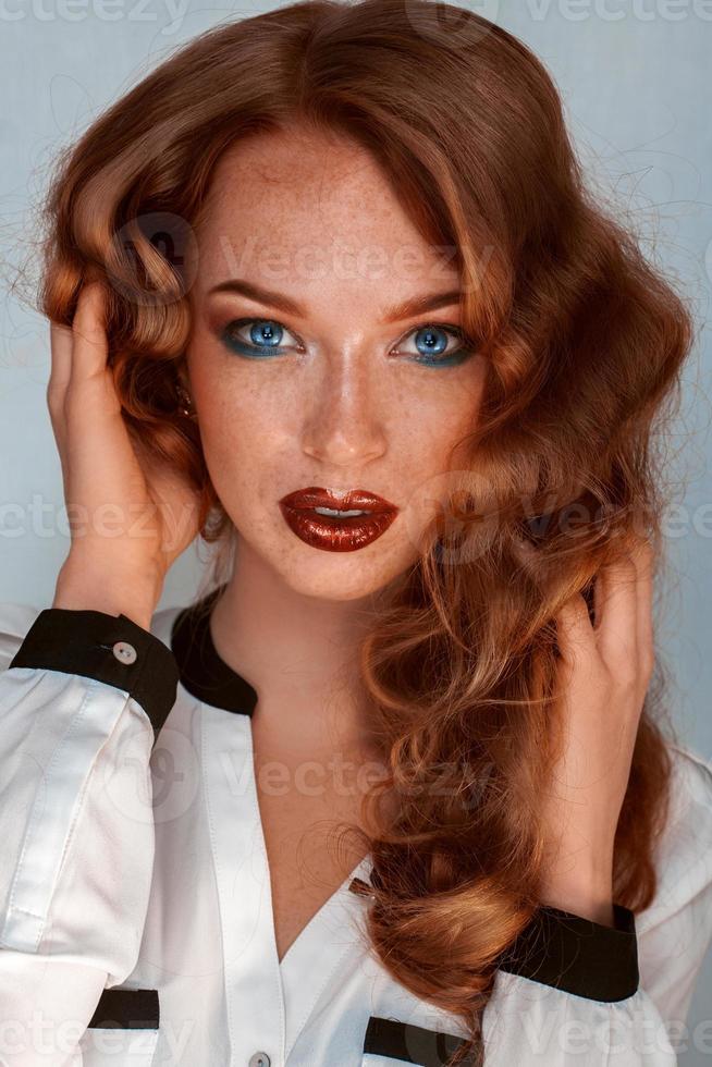 Brown hair woman with blue eyes and freckles on skin photo