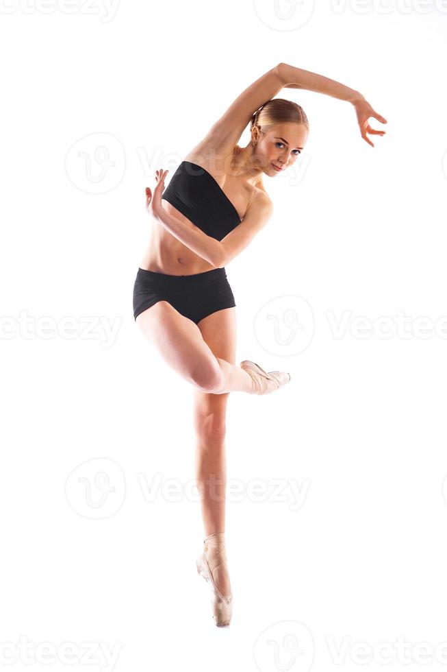 Pretty ballerina posing pn white background in training suit photo