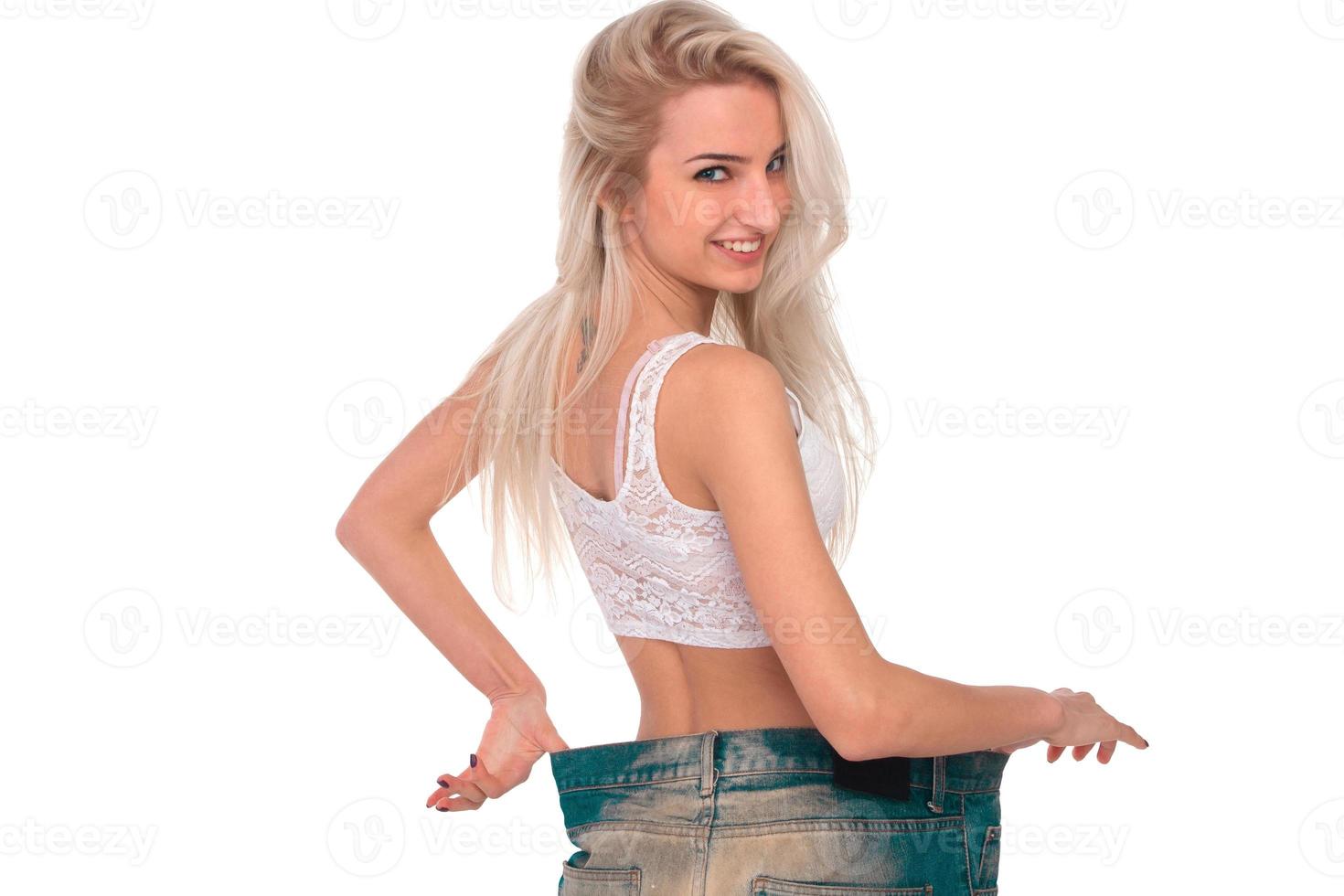 The girl tries on jeans photo