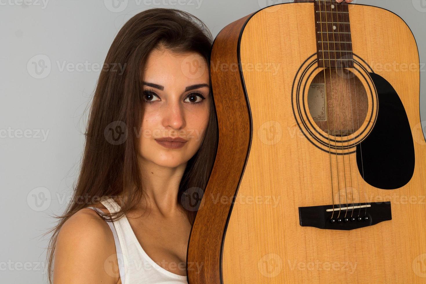 girl with guitar in studio photo