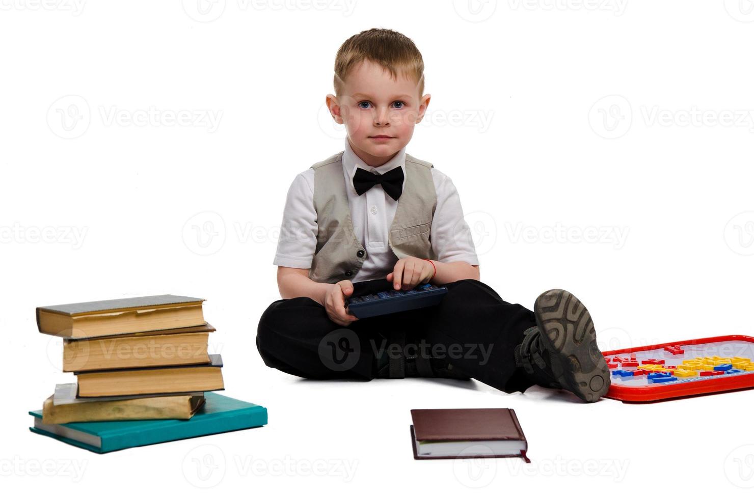 elegant little schoolboy studying photo