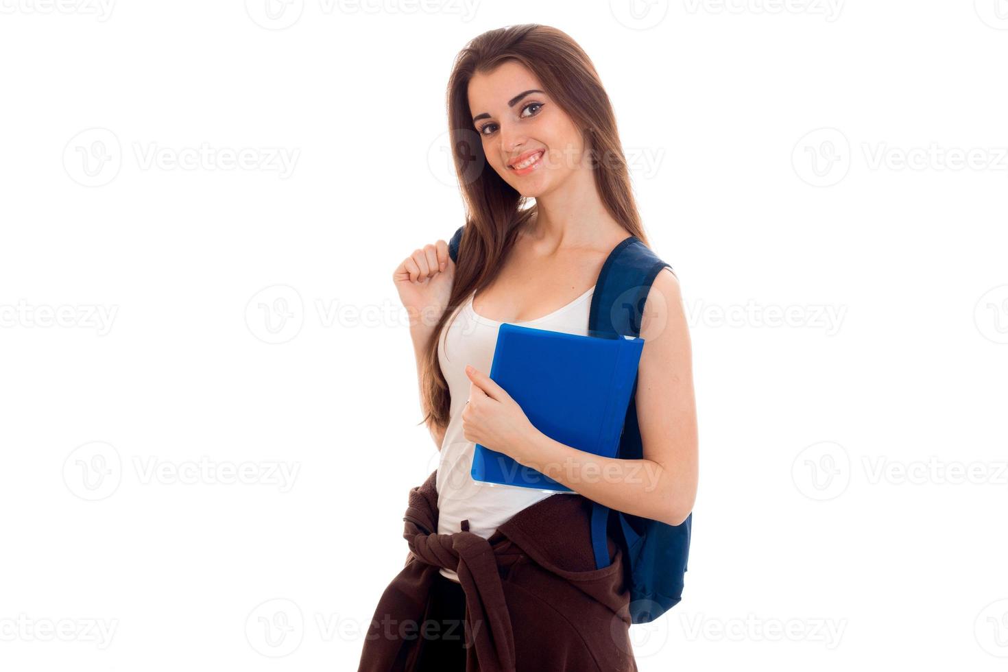 cheerful young student girl with backpack and books smiling on camera isolated on white background. student years concept. study concept. photo