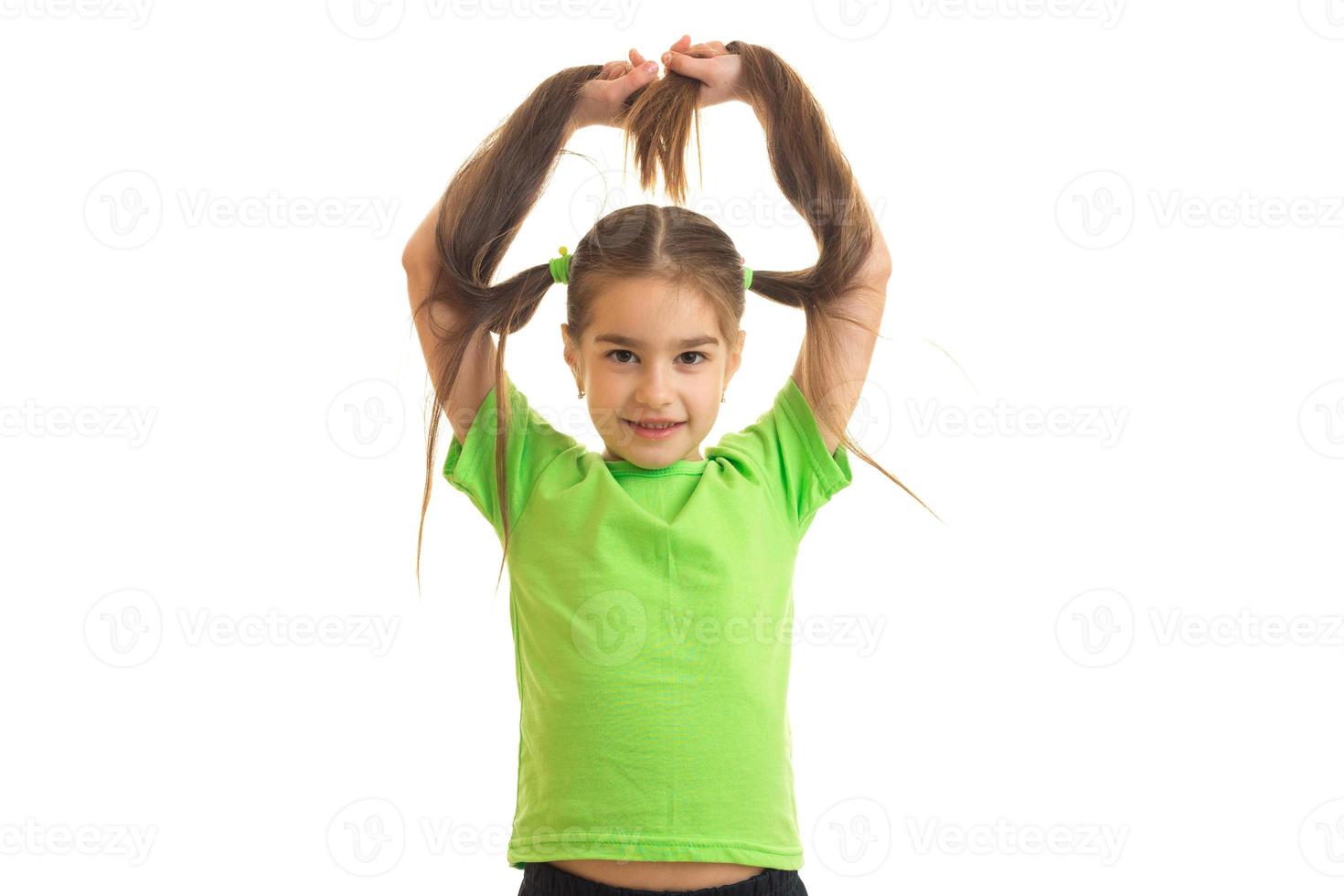 Funny girl in green shirt posing on camera photo