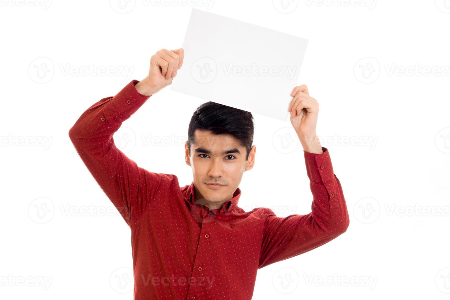 young cute male model in red shirt with empty placard in hands isolated on white background photo