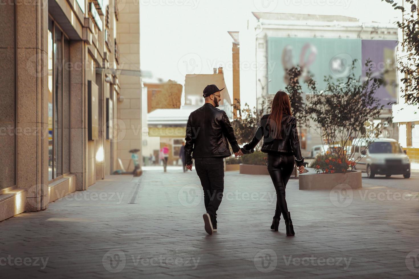 chraming couple in love walks down the street photo