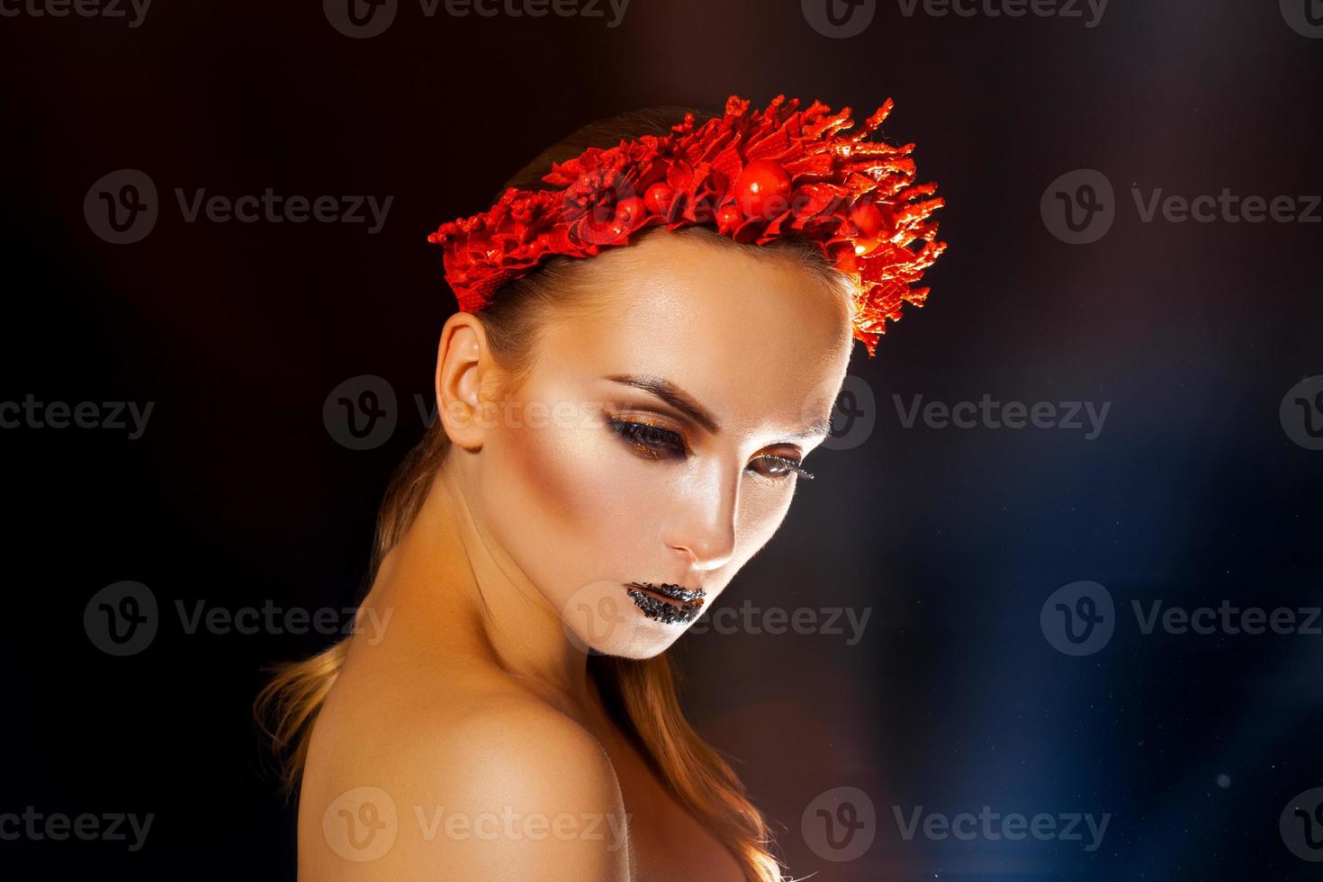 Attractive beauty girl with healthy skin and wreath on head on black background photo