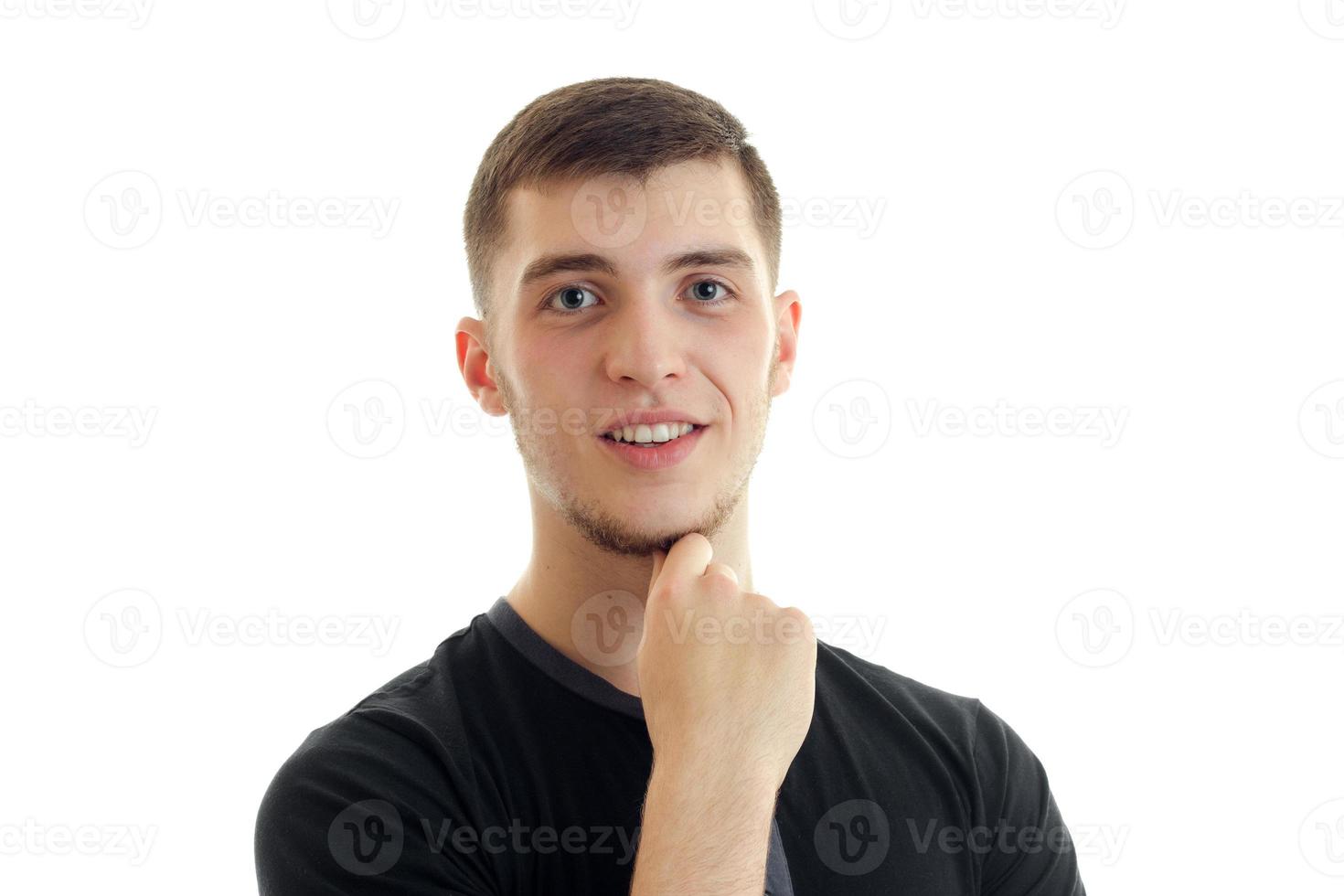 Portrait of a young cute guy who smiles and looks into the camera close-up photo