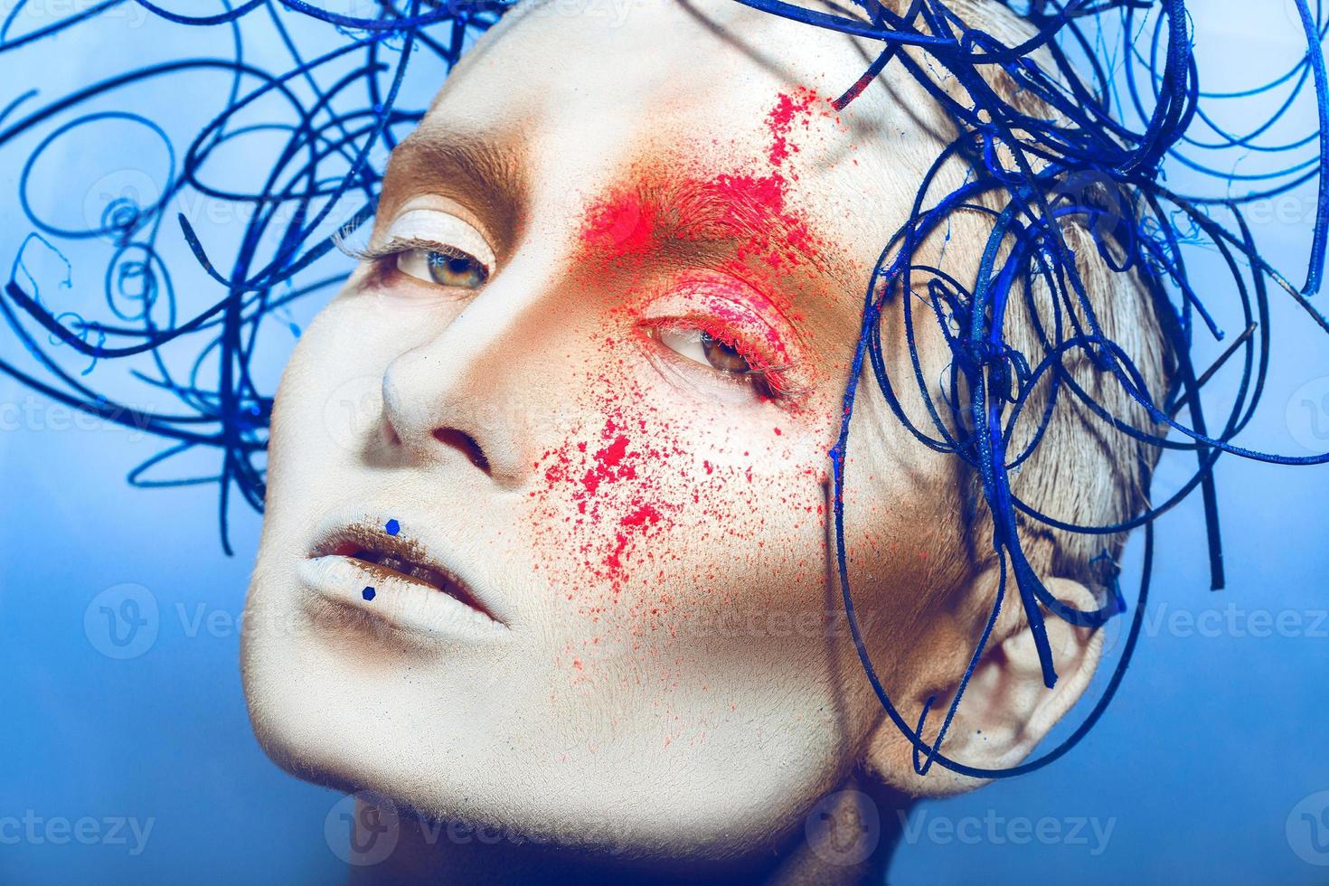 close up portrait of sexual woman with body art and neon powder photo