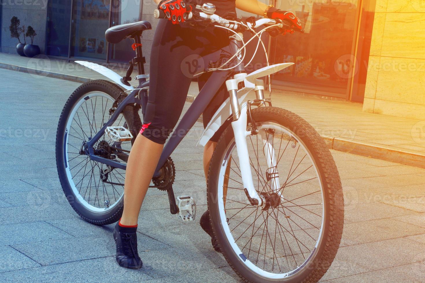 close up photo of beautiful female legs with bicycle