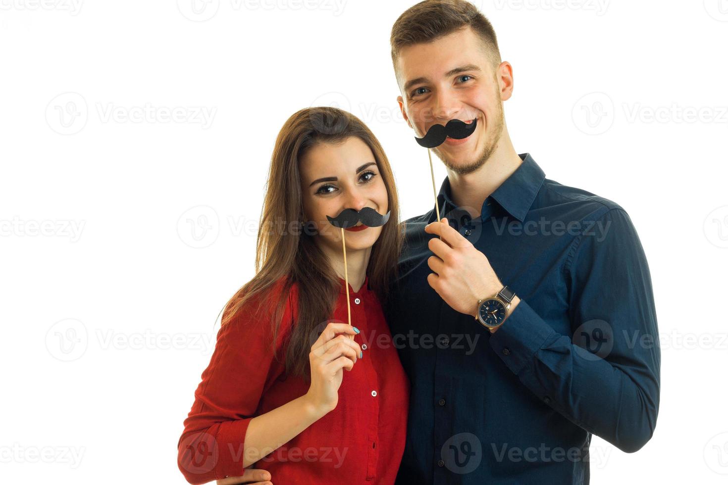 Gay couple having fun with paper moustache photo