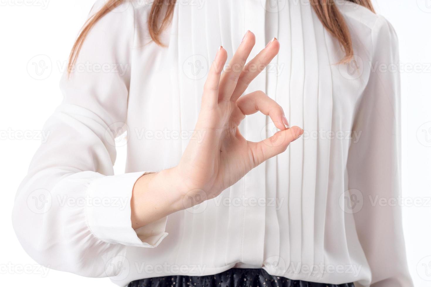 woman's hand outstretched in front of you and showing the gesture Okey close-up photo