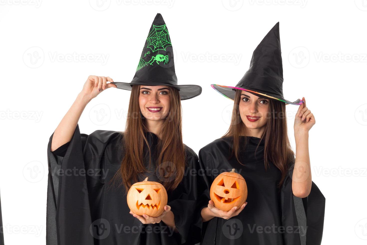 beauty young girls with pumpkins in hands photo