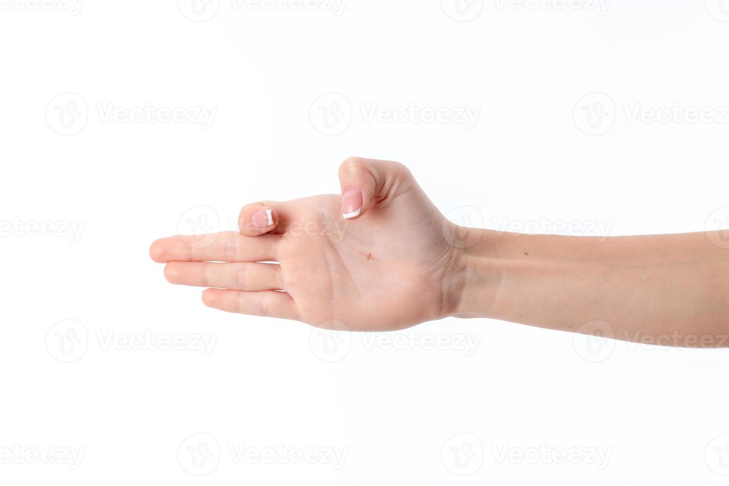 female hand outstretched to the side and showing the gesture with a bent index finger  thumb is isolated on  white background photo