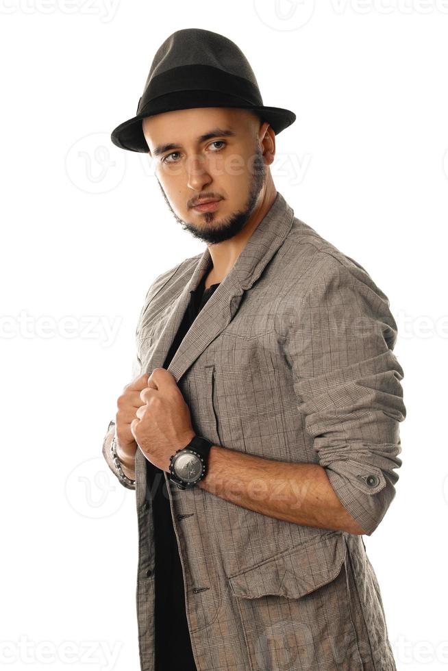 Handsome young man in hat and jacket looking away photo