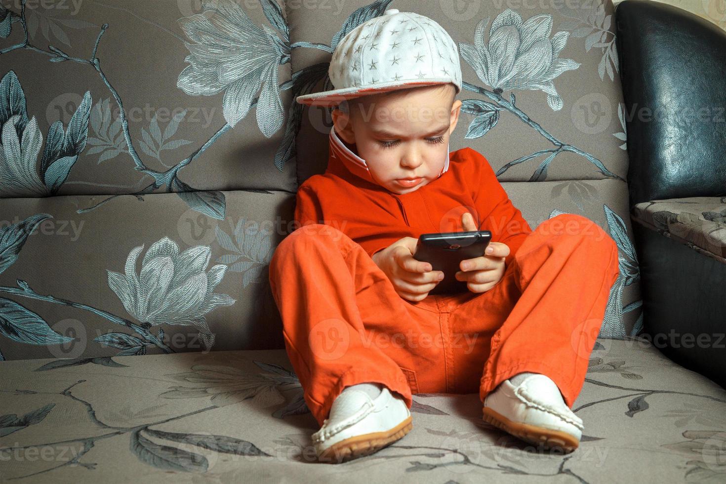 young boy in red suit and cap photo