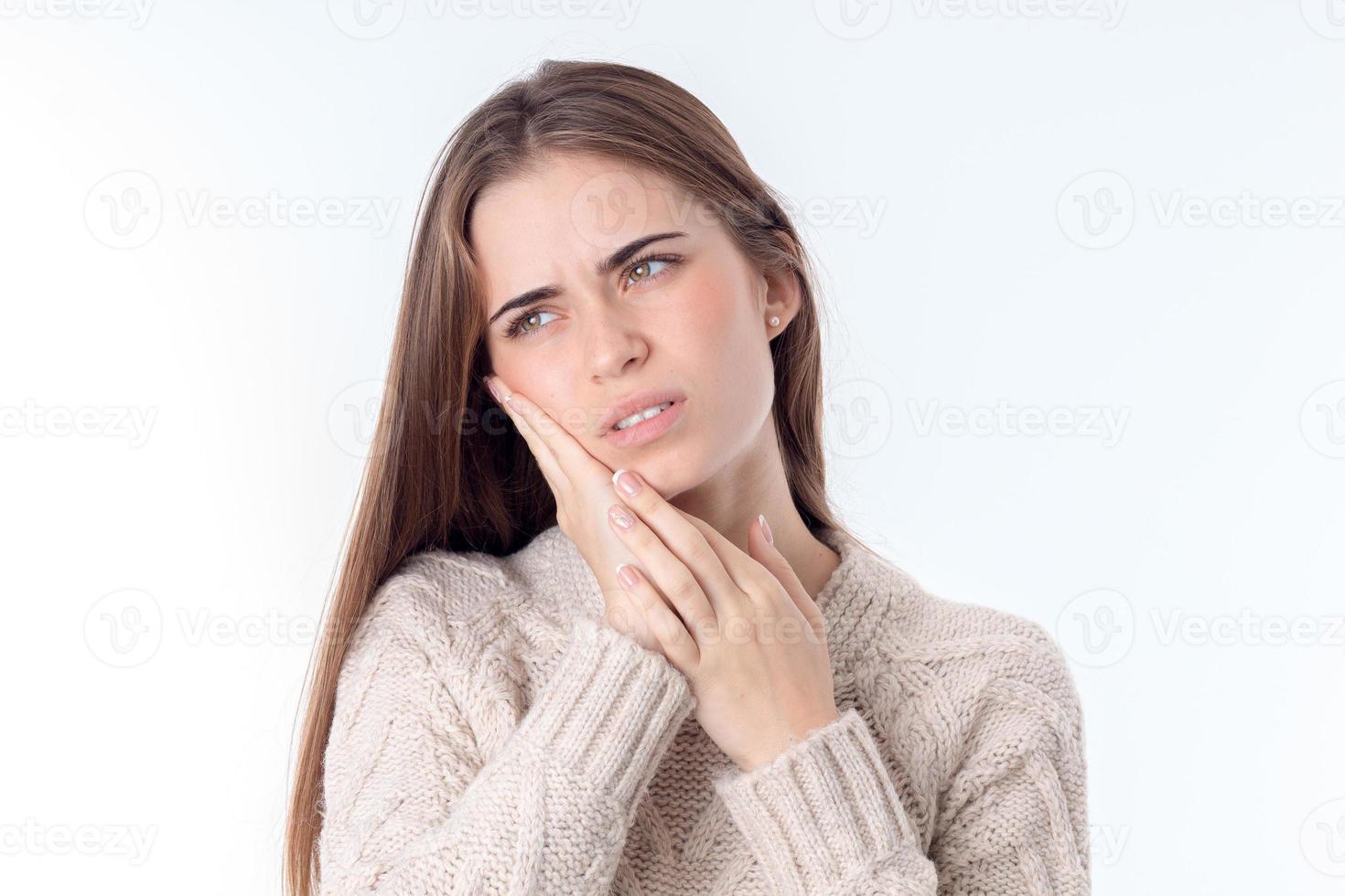young girl with dental pain that keeps Palm person isolated on white background photo