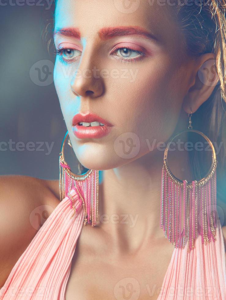 Woman with pink make up looking away photo