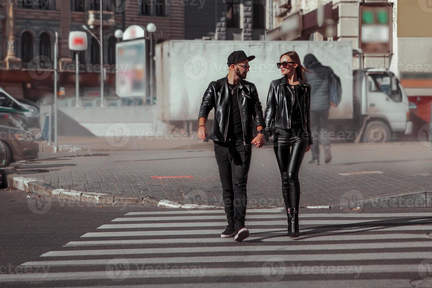 glamour couple walks across the road photo