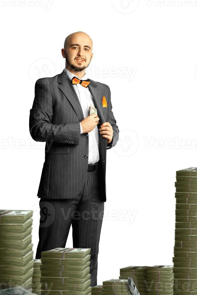 Isolated on white background joyful rich businessman in a suit with a bunch of money photo