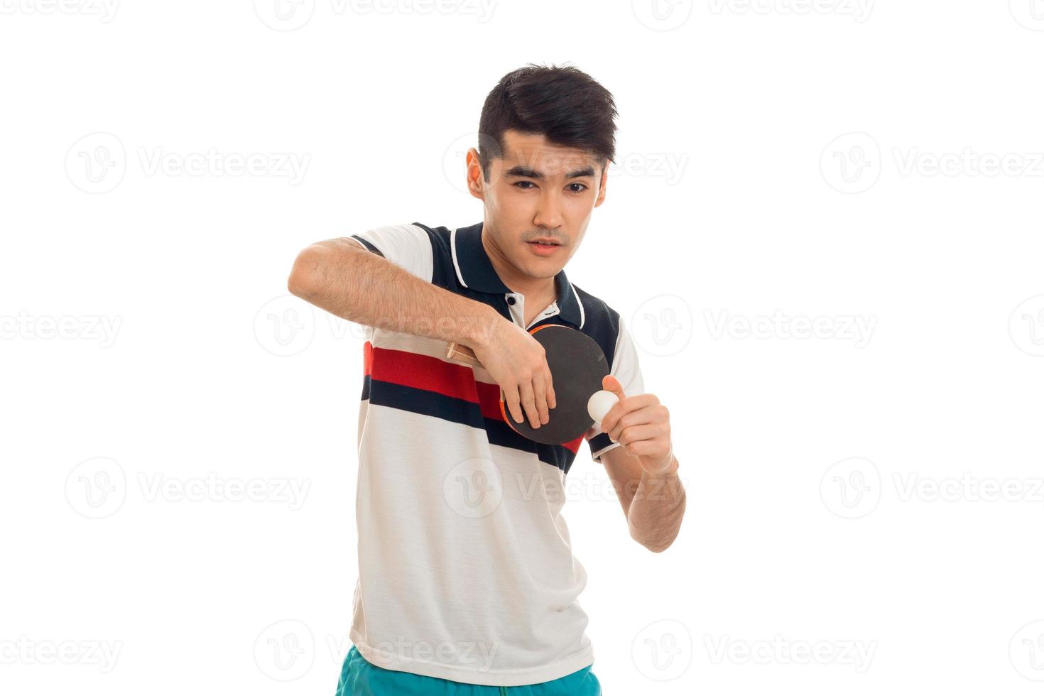 concentrated young brunett sportsman practicing ping-pong isolated on white background photo