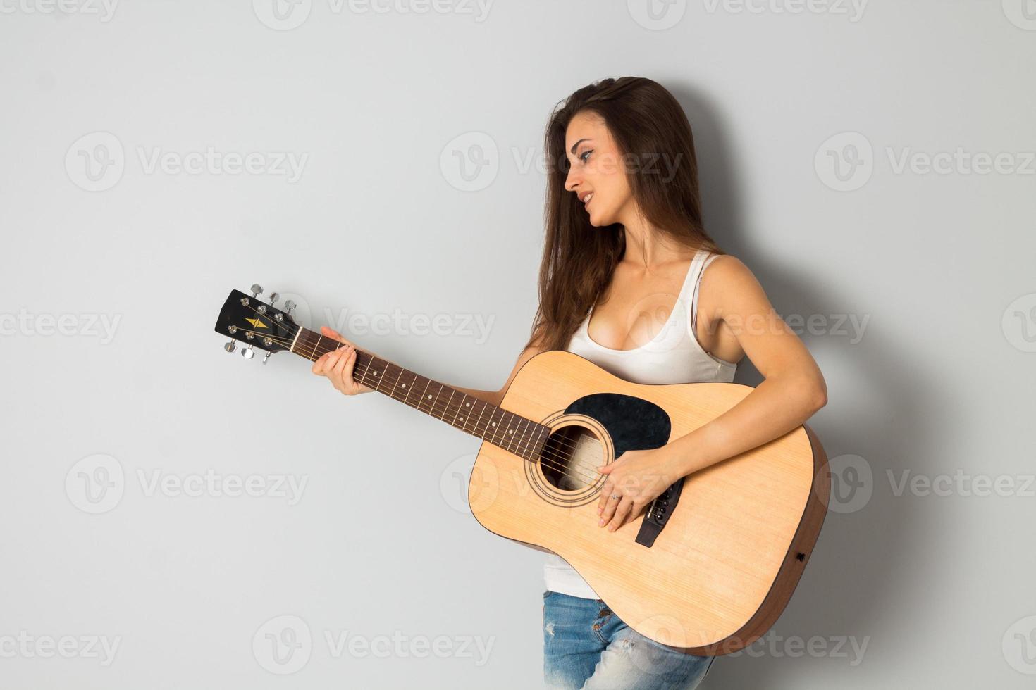 beautiful young brunette woman with guitar photo