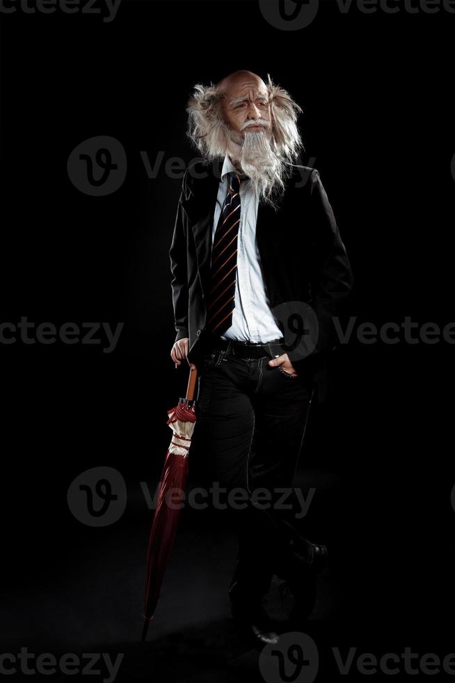 handsome old man in a classic suit posing in studio photo