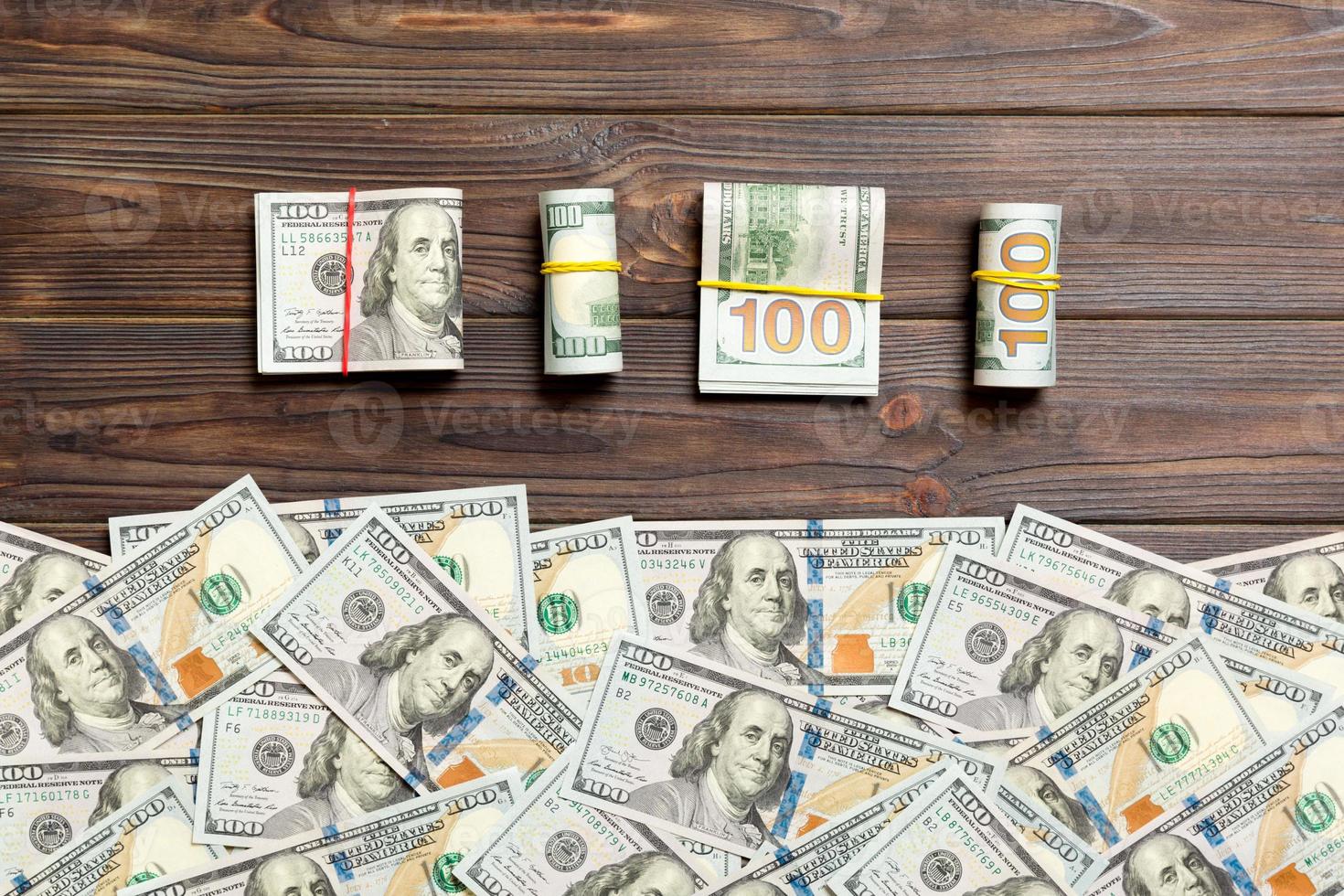 dollars currency on colored background top view, with empty place for your text business money concept. One hundred dollar bills with stack of cash photo