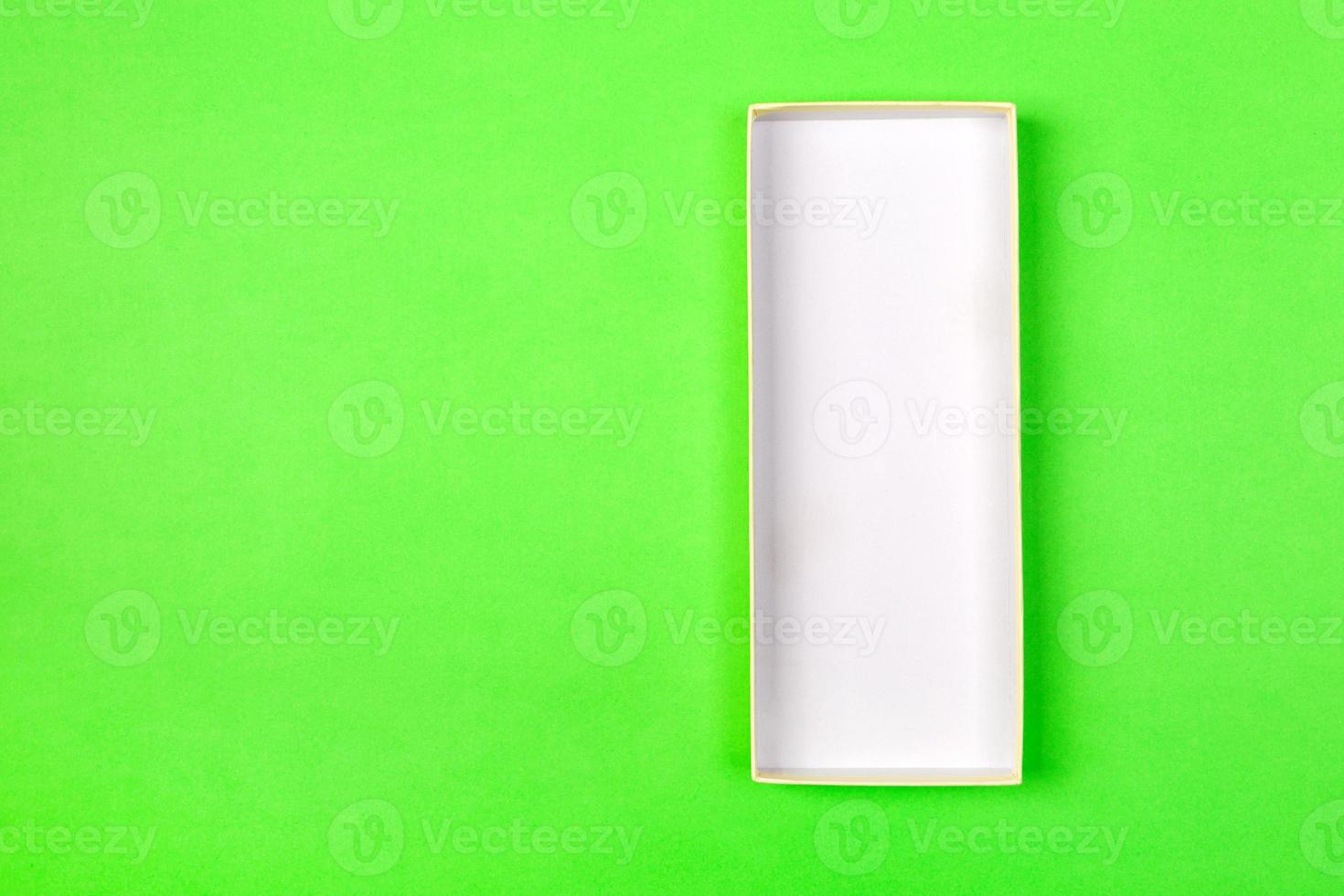 Empty box for product on green background. top view photo