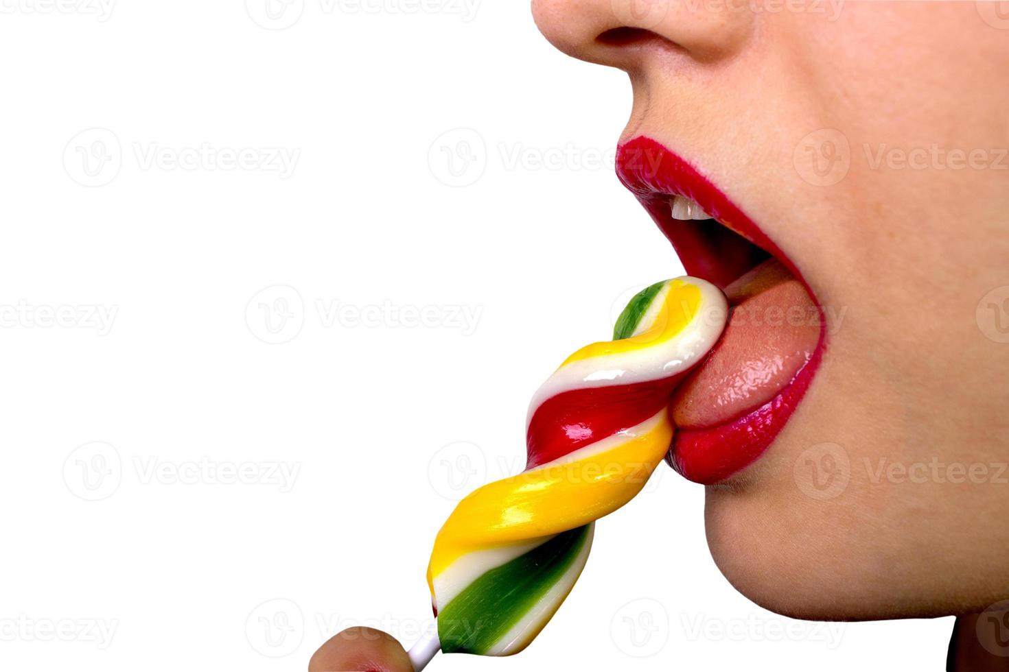 Sexy woman with red lips holding lollipop photo