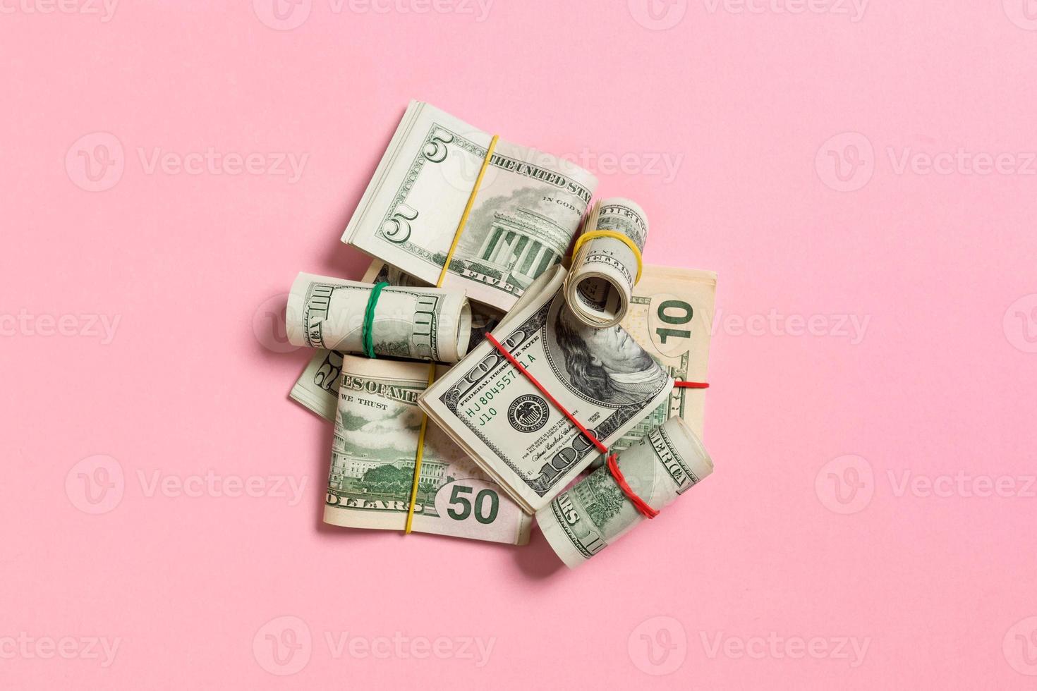 Stacks of one hundred dollars banknotes close-up on colored background business concept top view with copy space photo