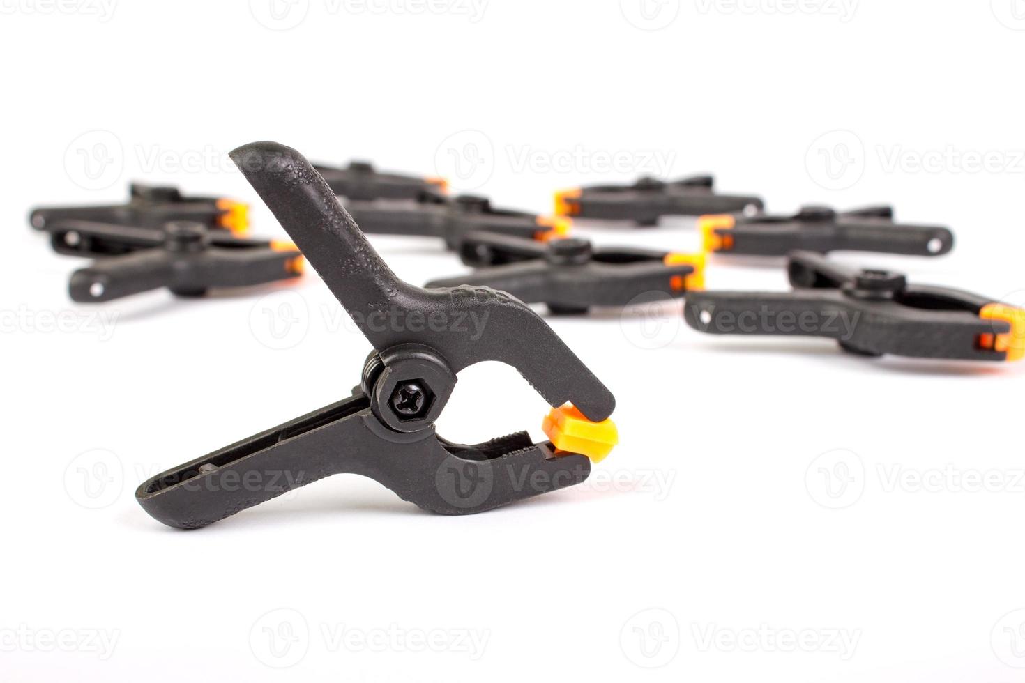 Clothespin. Carpentry clamps. Plastic clothespin on a white. photo