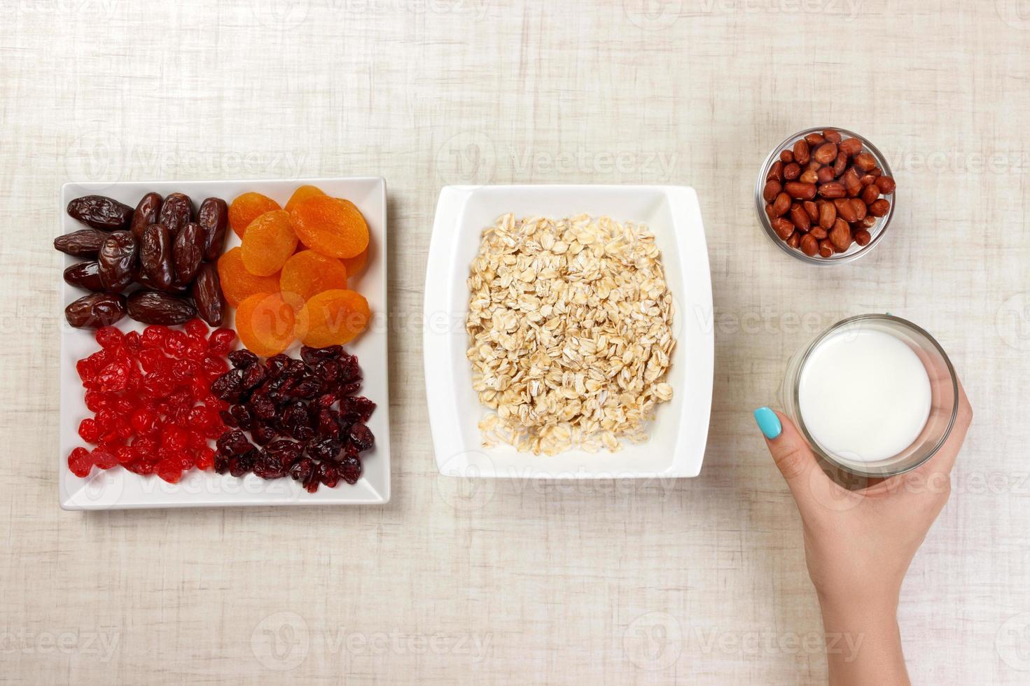 la niña tomó leche para verterla en avena. desayuno útil y saludable. Fondo blanco foto