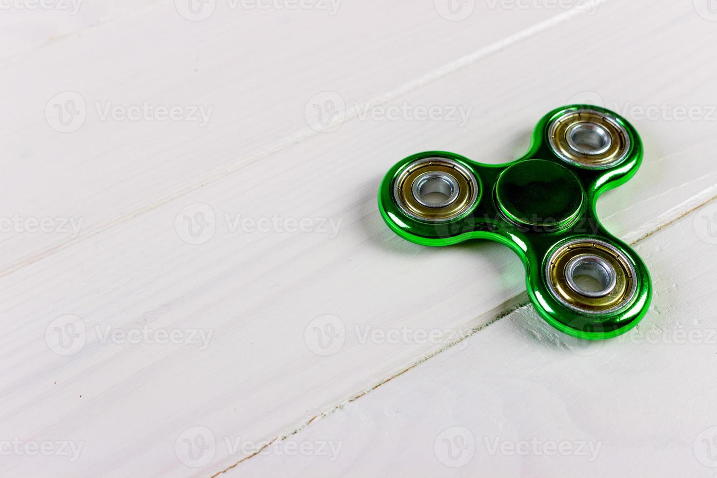 Close up shot of an green fidget spinner photo